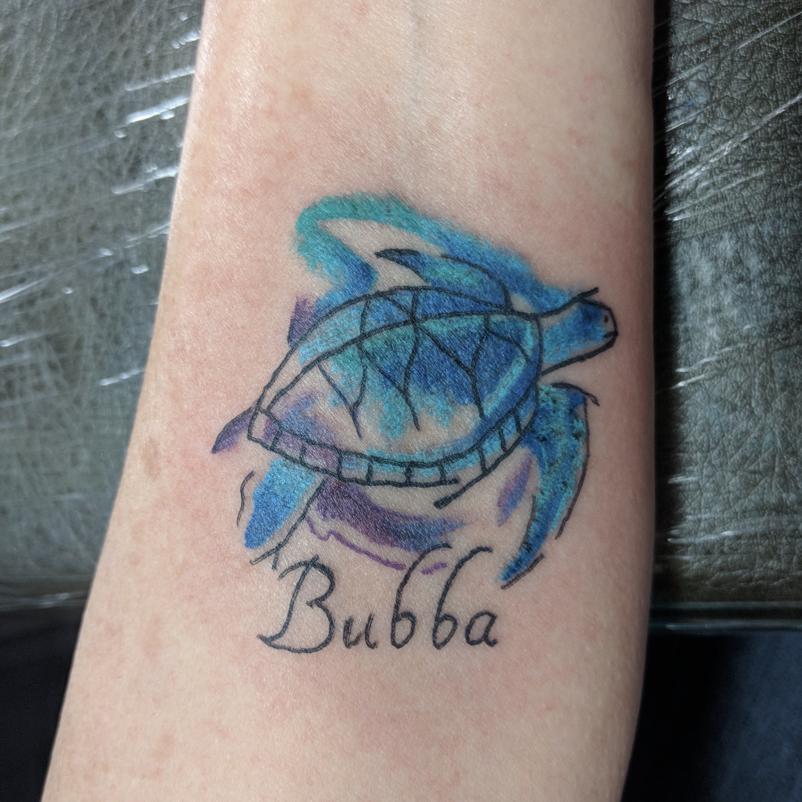 Image of a colorful watercolor style turtle memorial tattoo