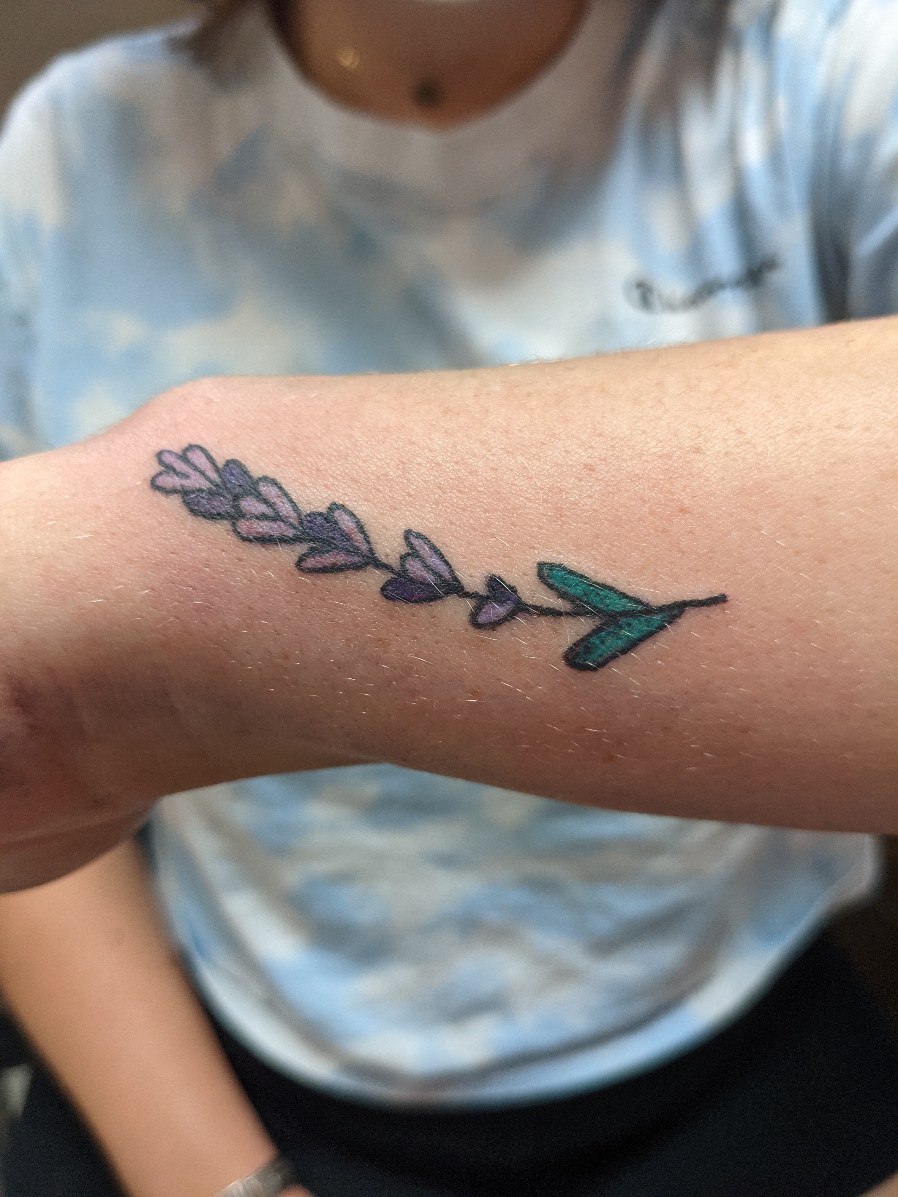 Photo of a color lavender tattoo on a wrist
